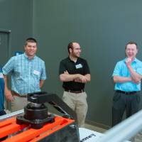 A group of guests laughing together at the Engineering Design Project Preview